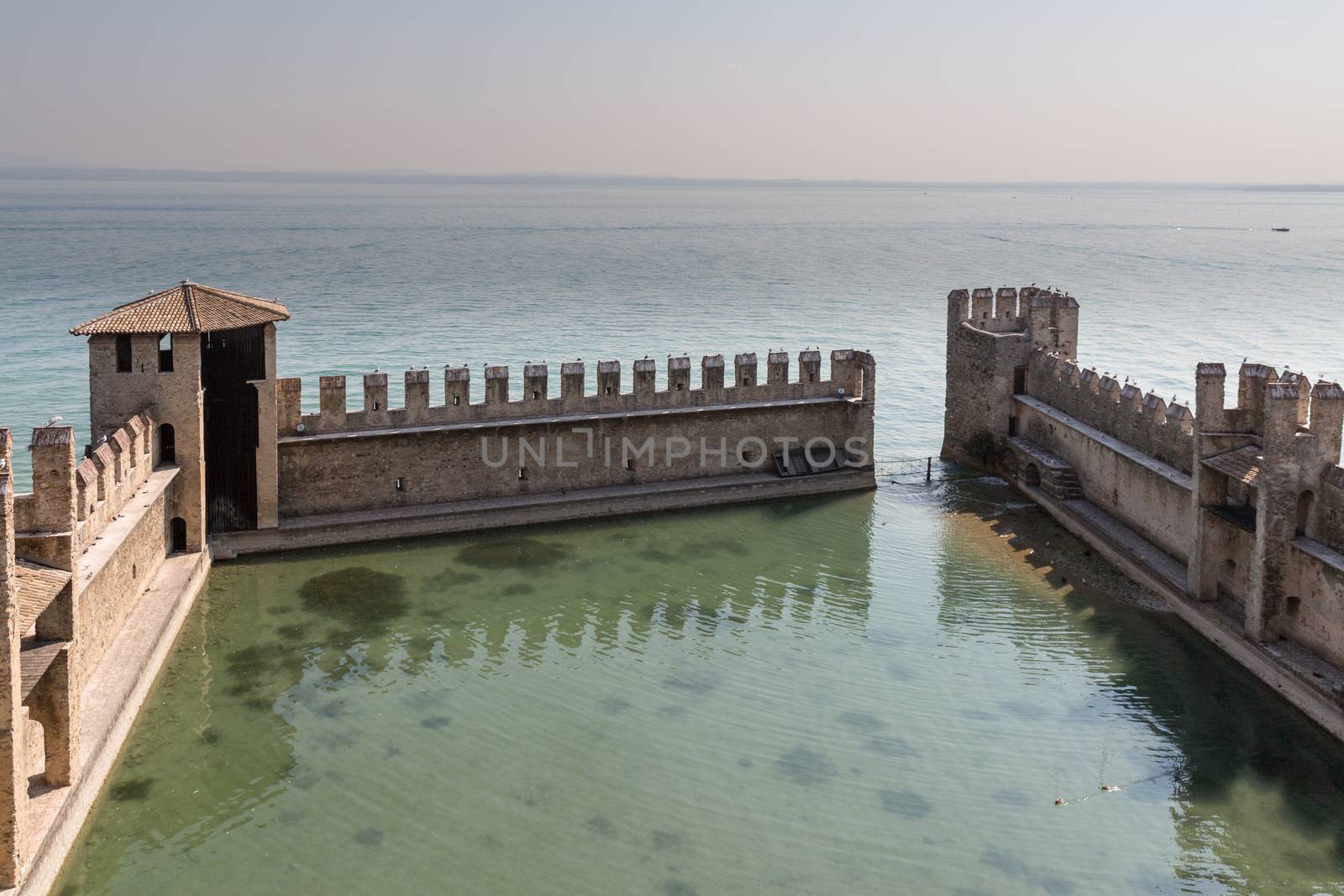 The fortress walls of Castello Scaligero in Sirmione on Lake Garda in Italy