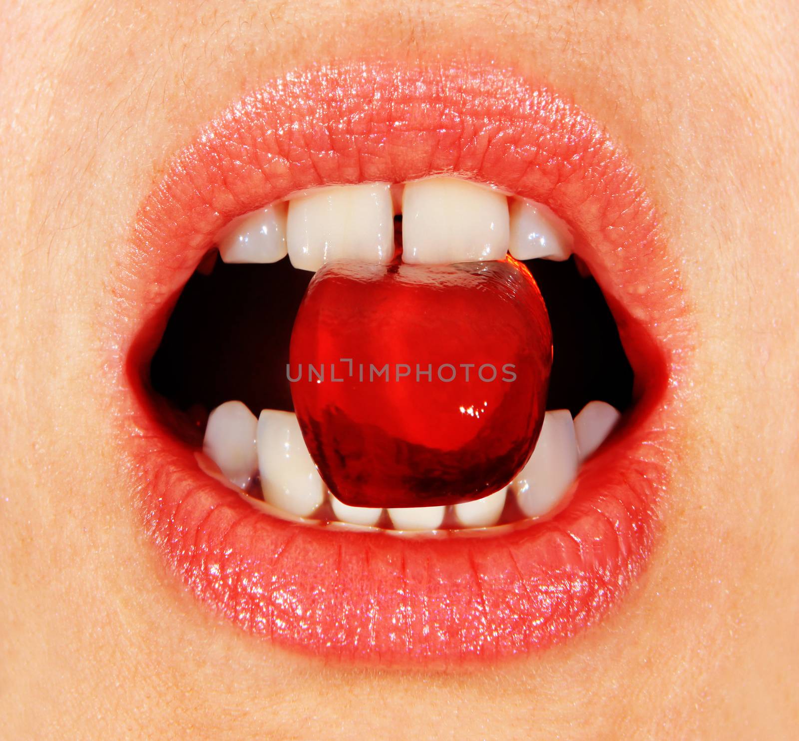red lollipop in the woman's mouth