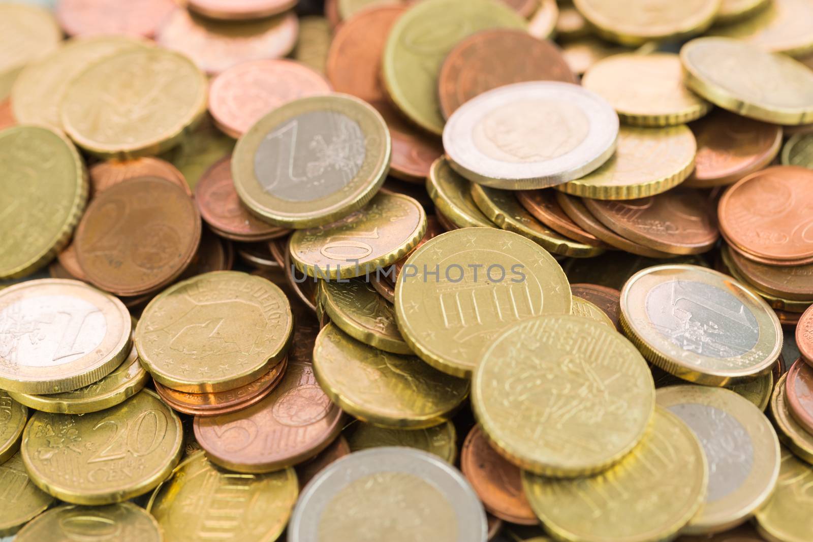 Heap of assorted Euro coins in different denominations in a vertical shallow dof view in a full frame financial background