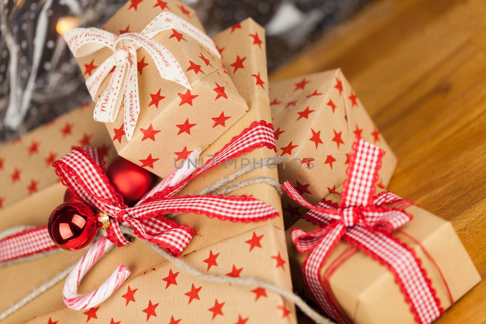 Close-up composition of Christmas present boxes of kraft paper with ribbons, decorations and stars pattern