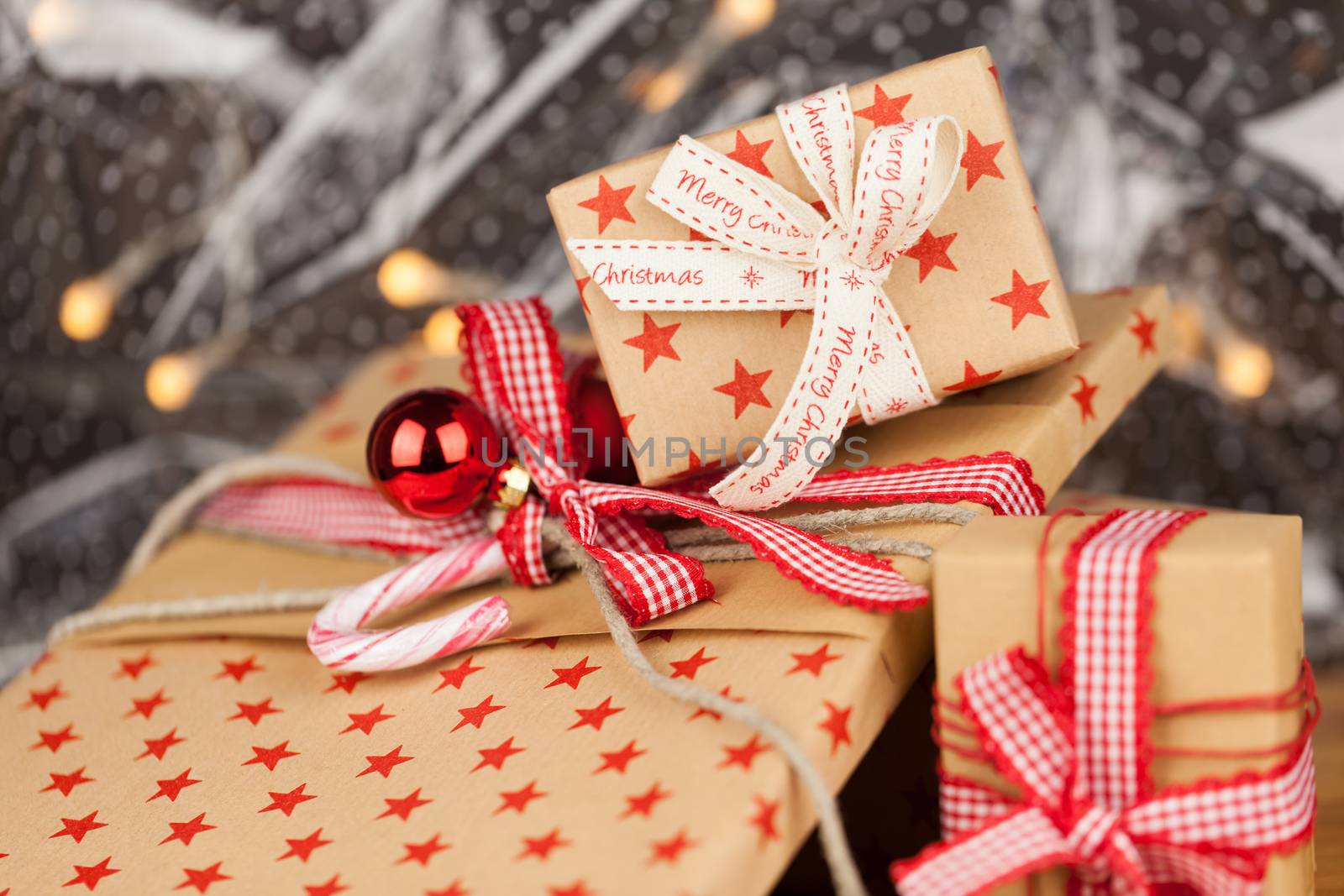Close-up composition of Christmas present boxes of kraft paper with ribbons, decorations and stars pattern