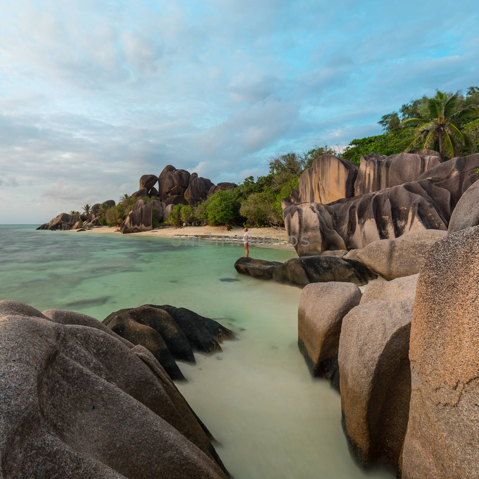 Beautifully shaped granite boulders and a dramatic sunset at picture perfect tropical Anse Source d'Argent beach, La Digue island, Seychelles.