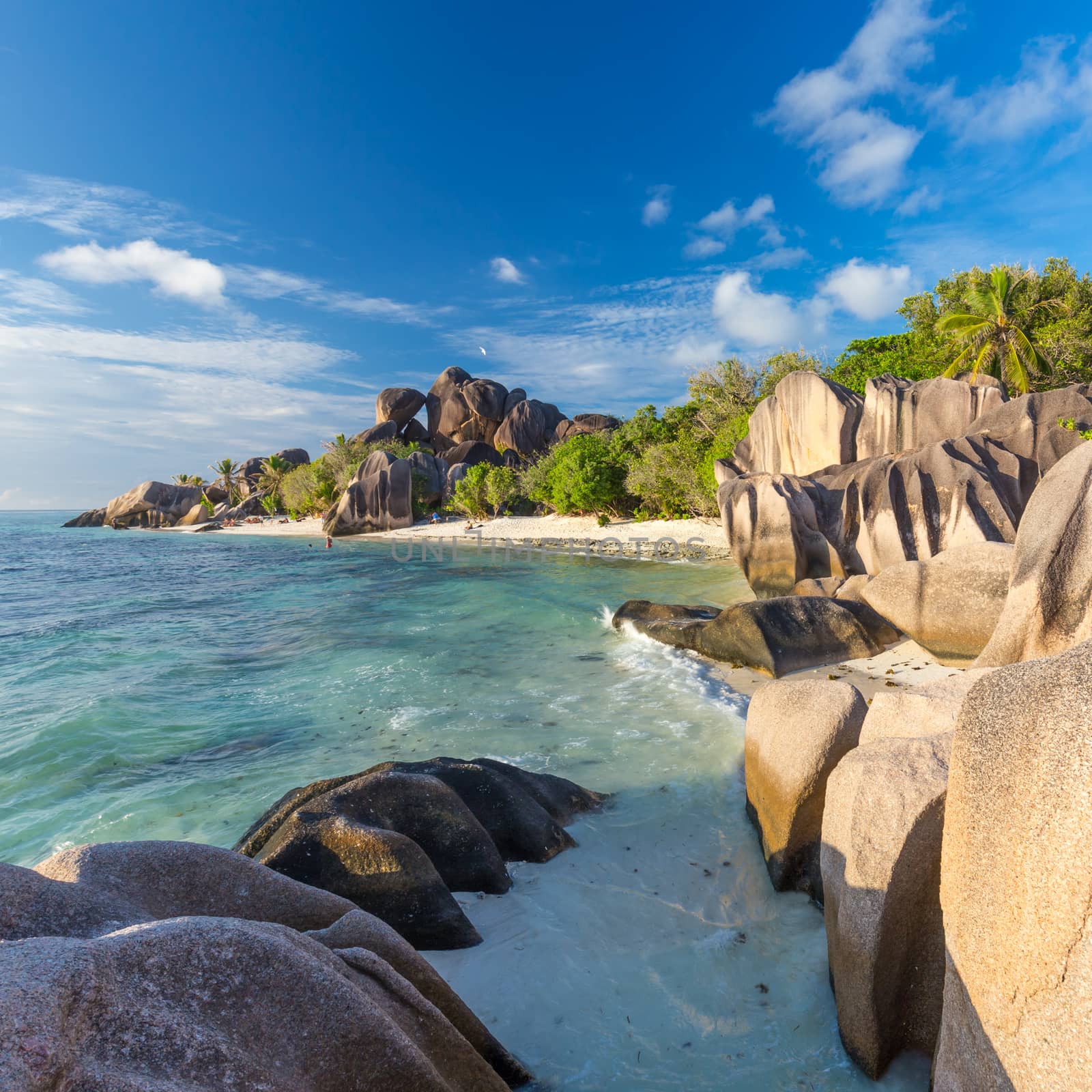 Beautifully shaped granite boulders in illuminated by summer sun on picture perfect tropical Anse Source d'Argent beach, La Digue island, Seychelles.