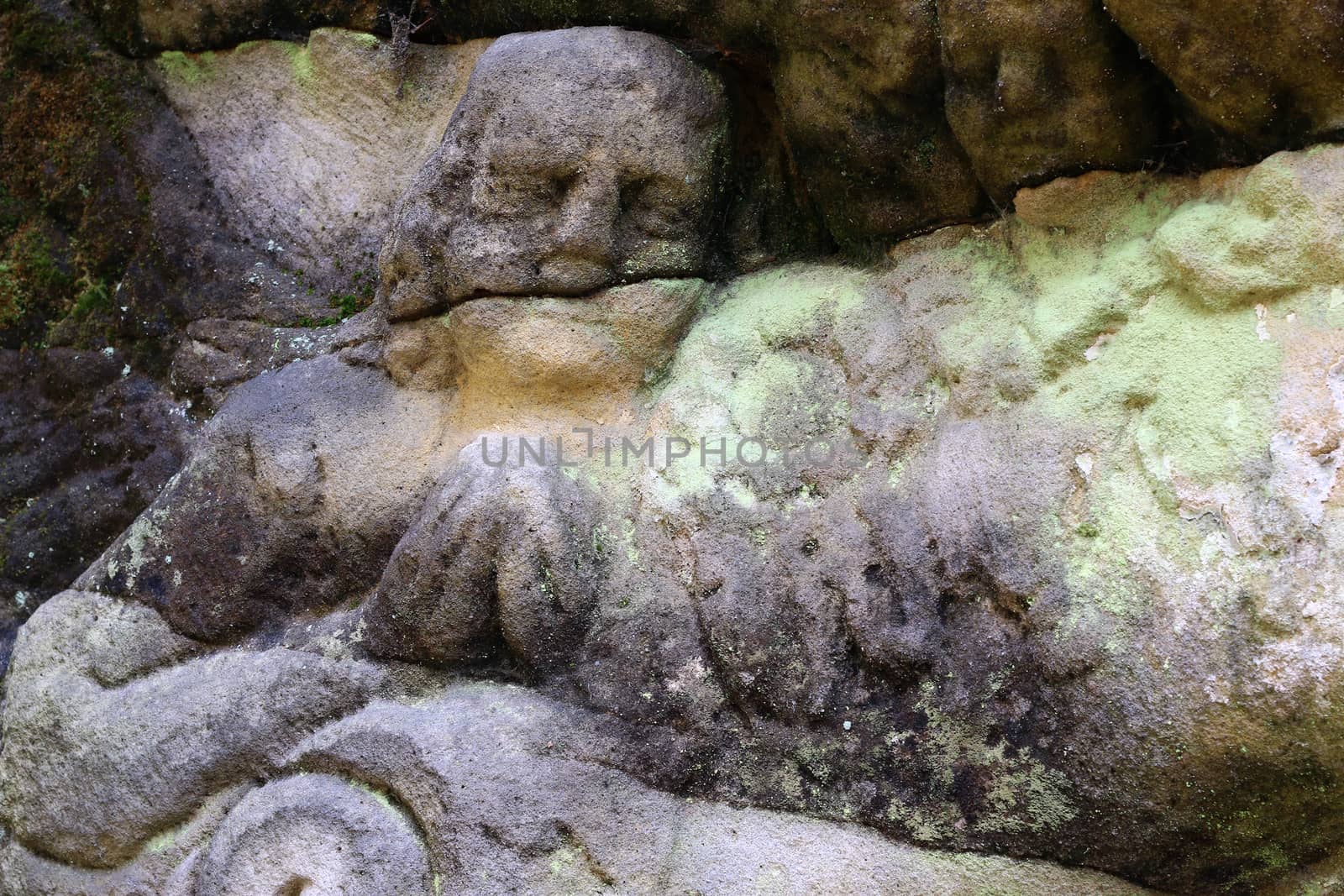 Stone altar carved into the sandstone - detail of the head of a praying angel.
Stone altar carved in sandstone cliff in the forest near the village Marenicky, Lusatian Mountains, Czech Republic.
