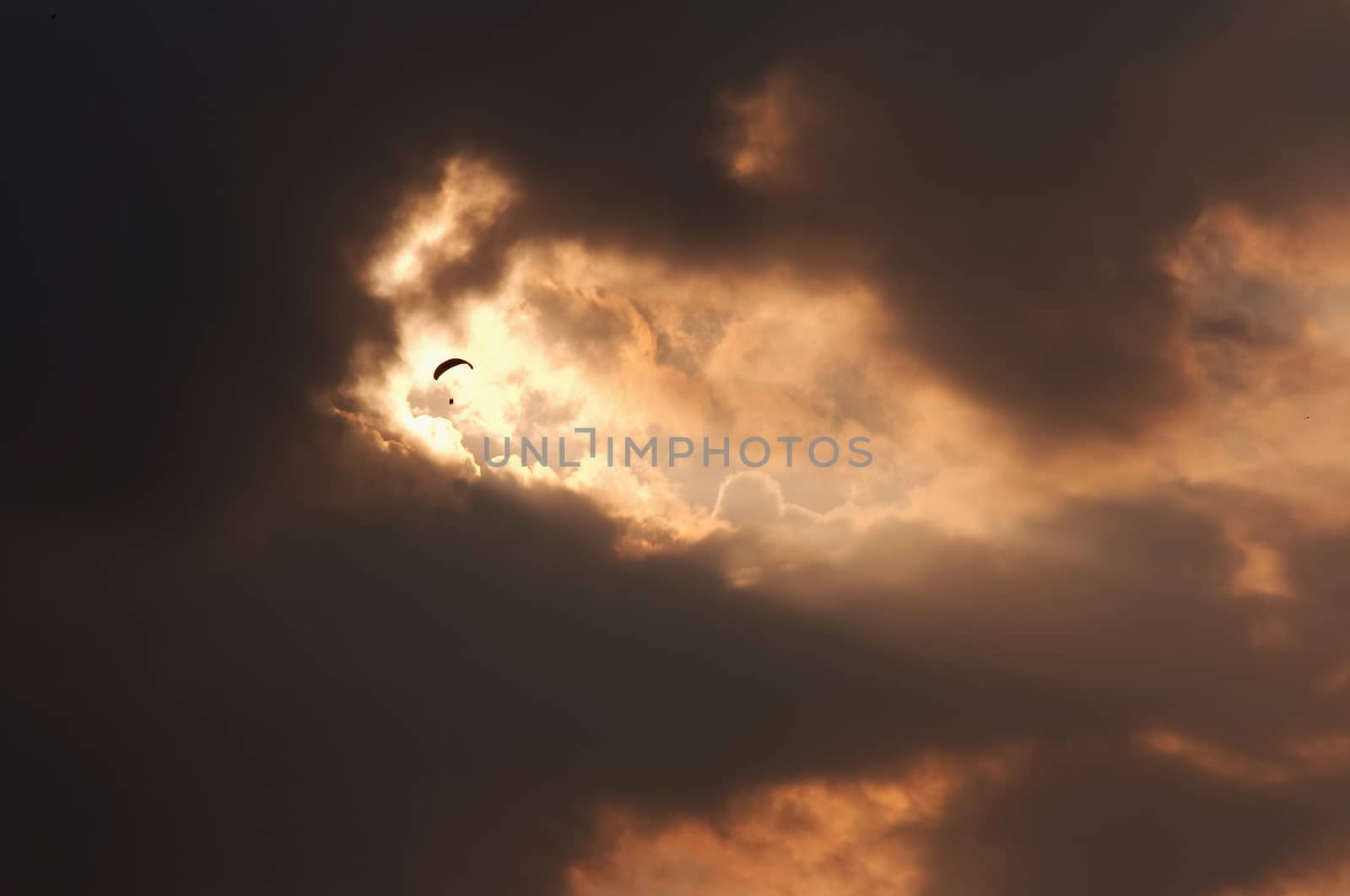 Image of the paraglider in the torn clouds