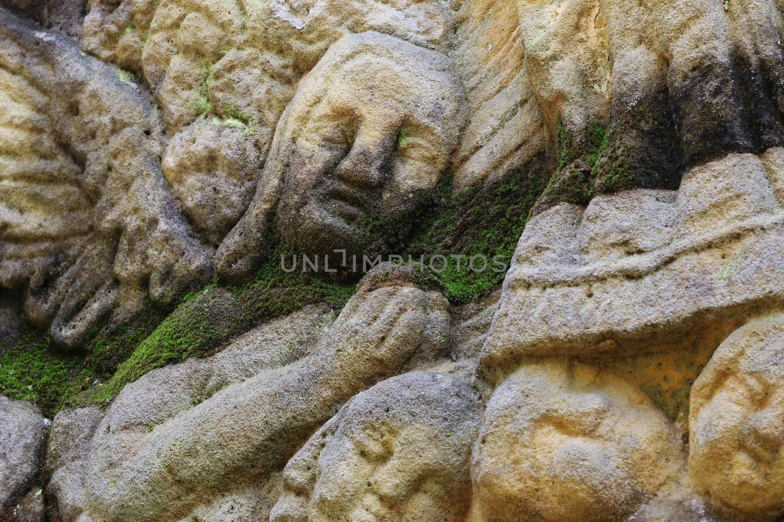 Stone altar carved into the sandstone - detail of the head of a praying angel.
Stone altar carved in sandstone cliff in the forest near the village Marenicky, Lusatian Mountains, Czech Republic.
