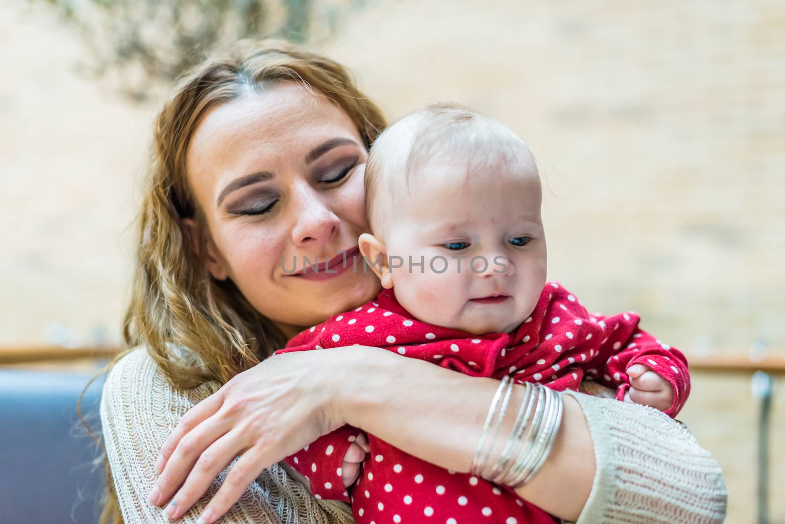 happy mother with a baby in her arms in the room