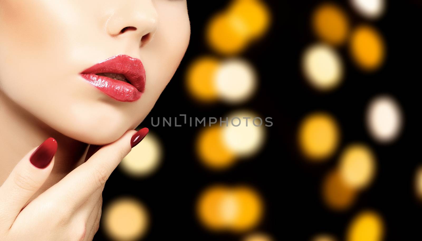 Beautiful woman face against an abstract background with blurred lights