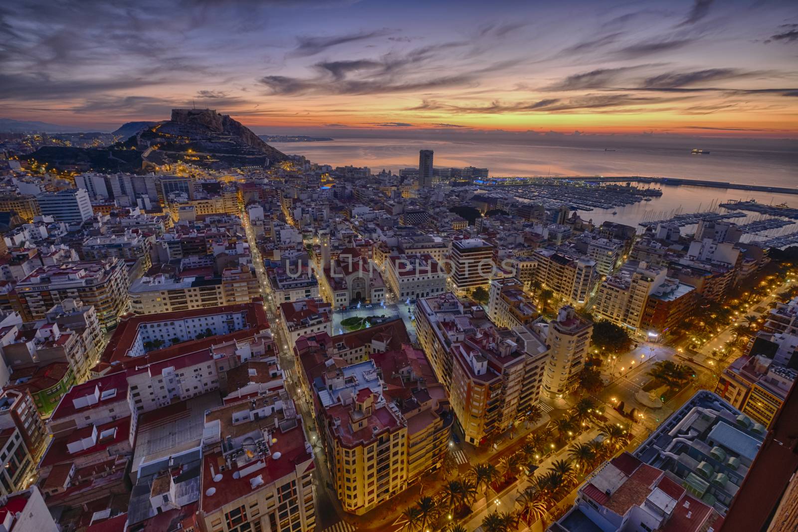 sunrise over the ancient city of Alicante in Spain and in the background the castle and harbor