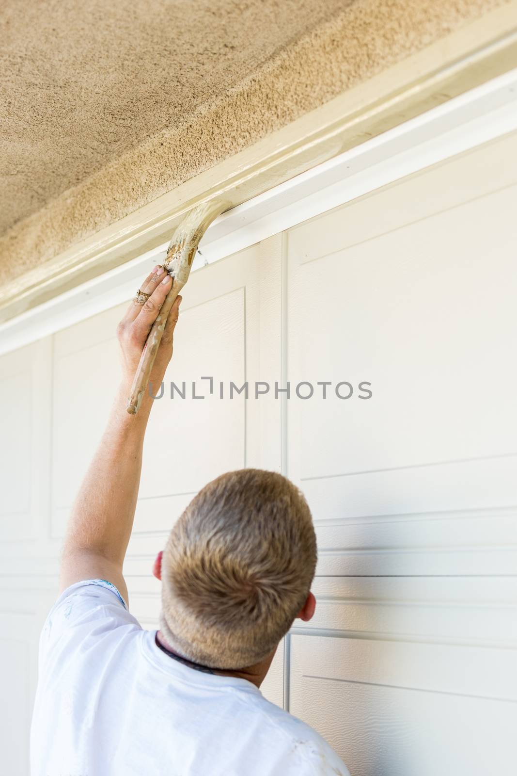 Professional Painter Cutting In With Brush to Paint Garage Door Frame by Feverpitched