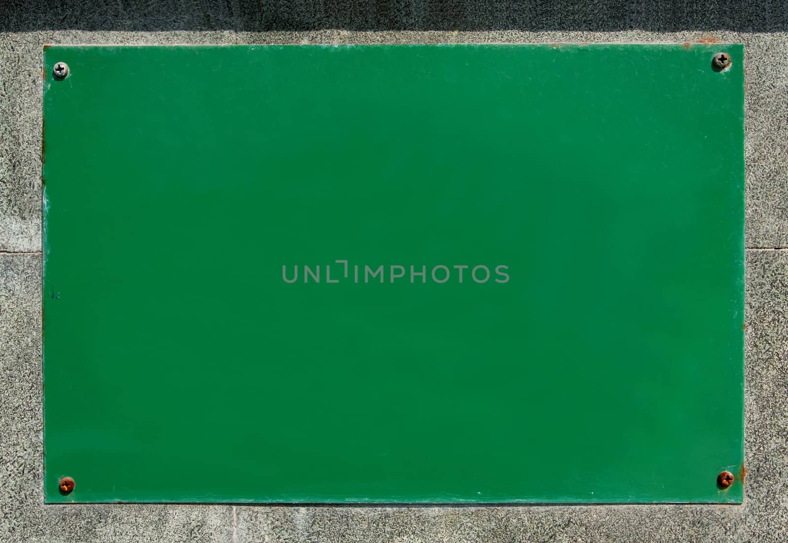 Green blank billboard on the stone wall background