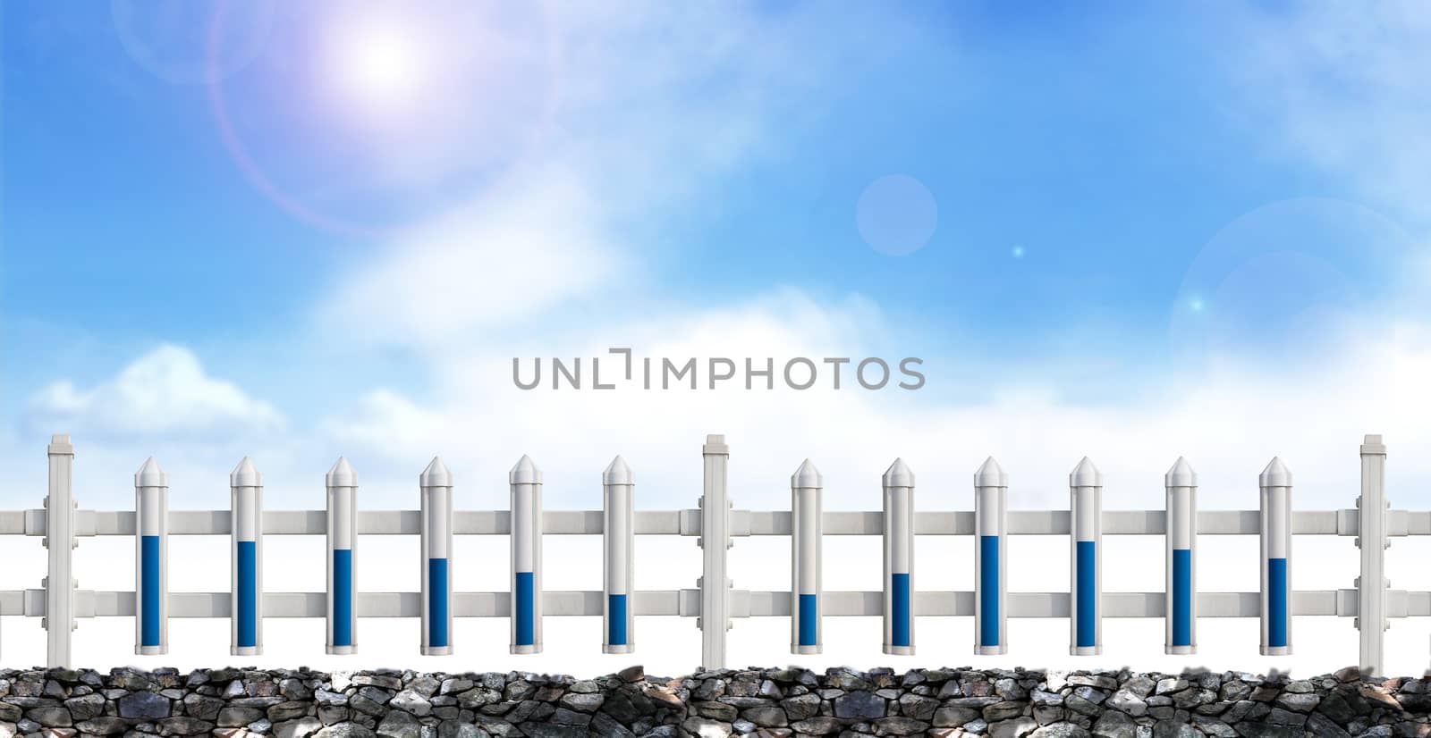 A row of white fence in the blue sky