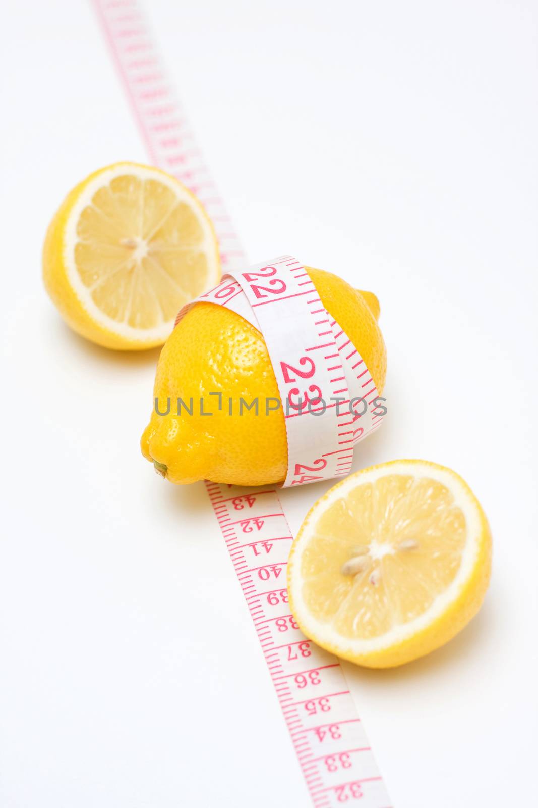Lemon and Tape measures isolated on white background by myyaym