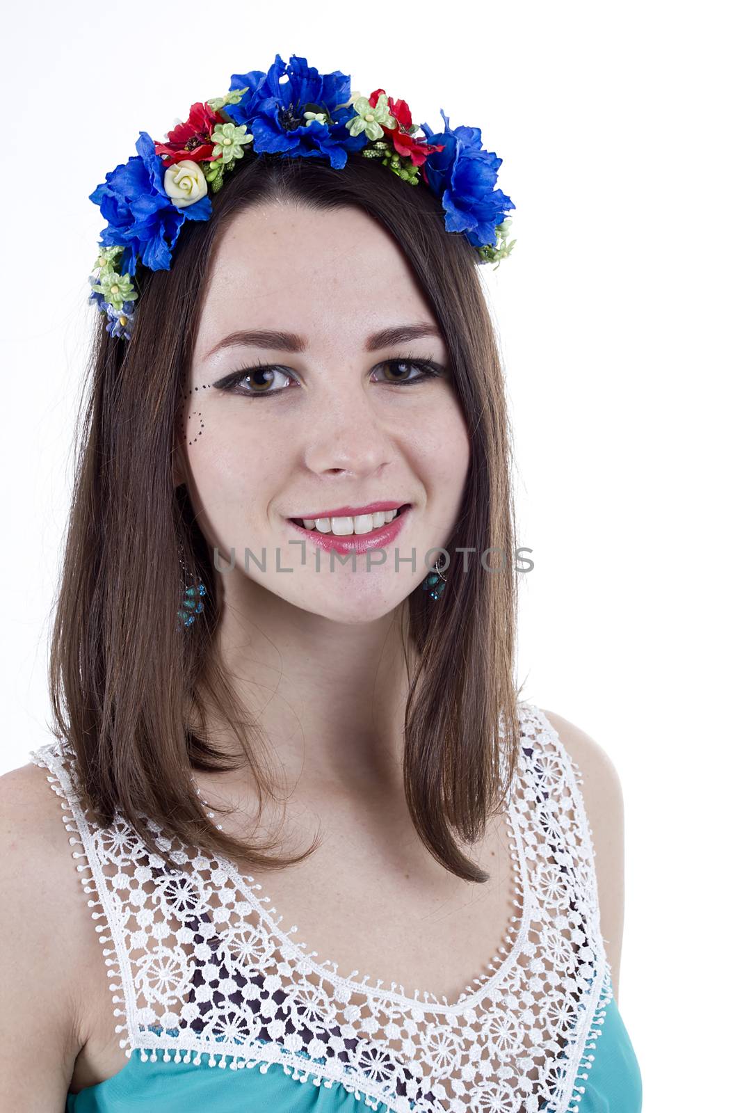 Studio portrait of a young beautiful woman with flower wreath on head.