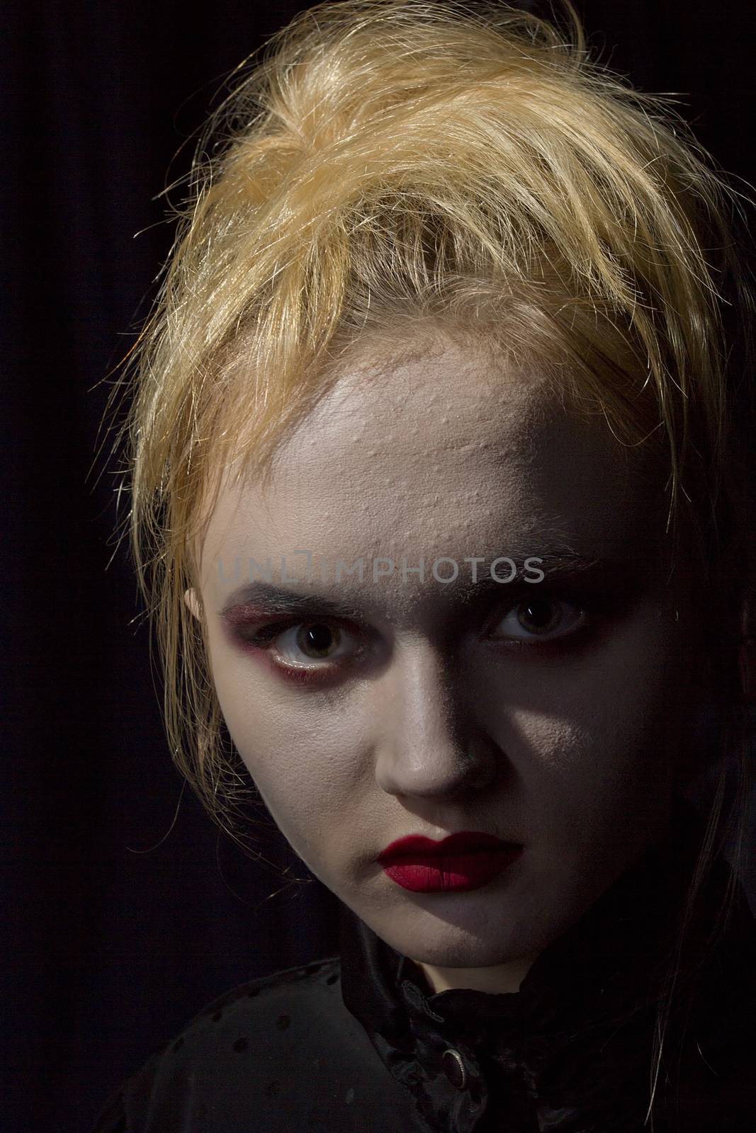 Young girl vampire on a black background