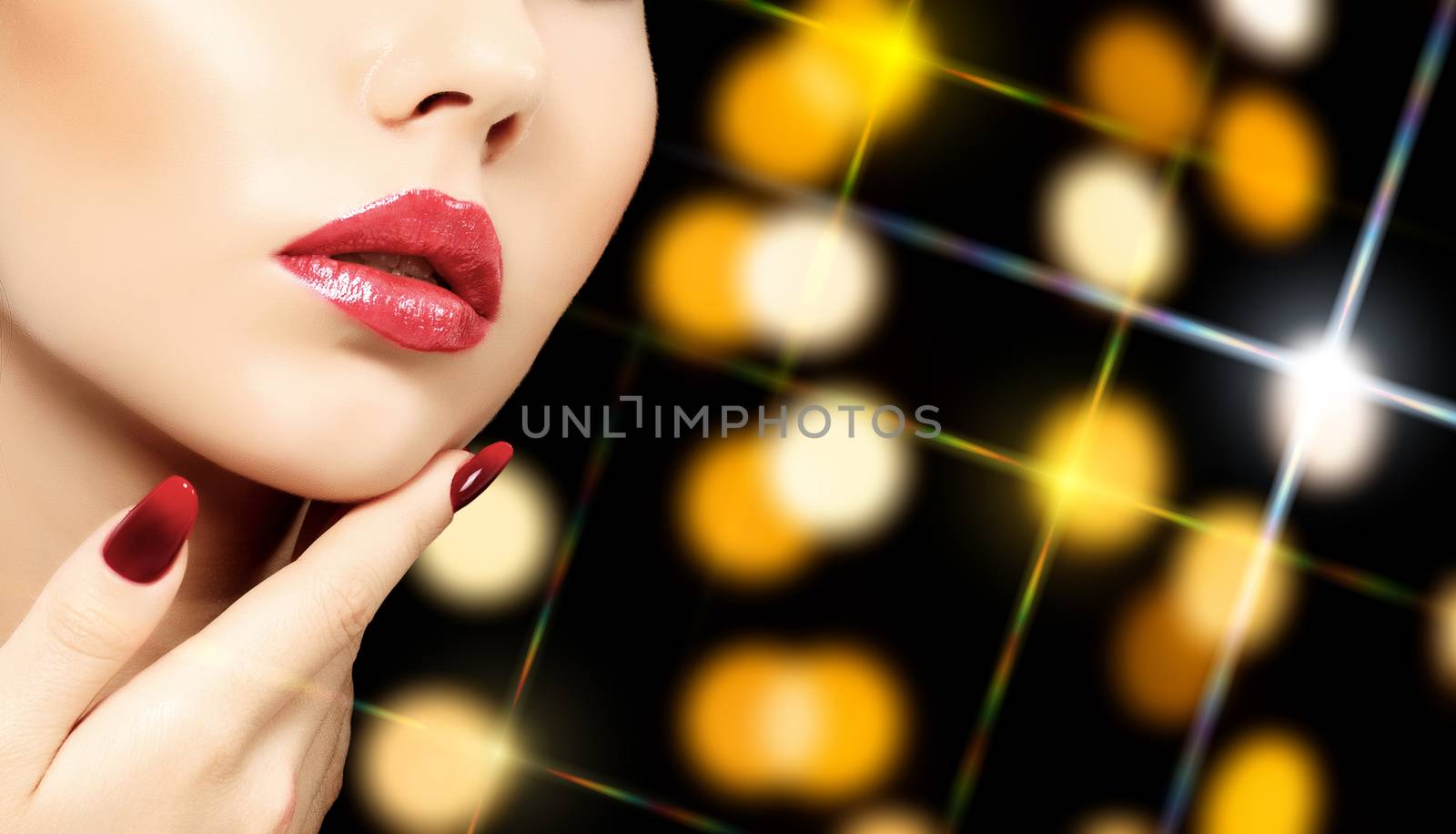 Beautiful woman face against an abstract background with blurred lights