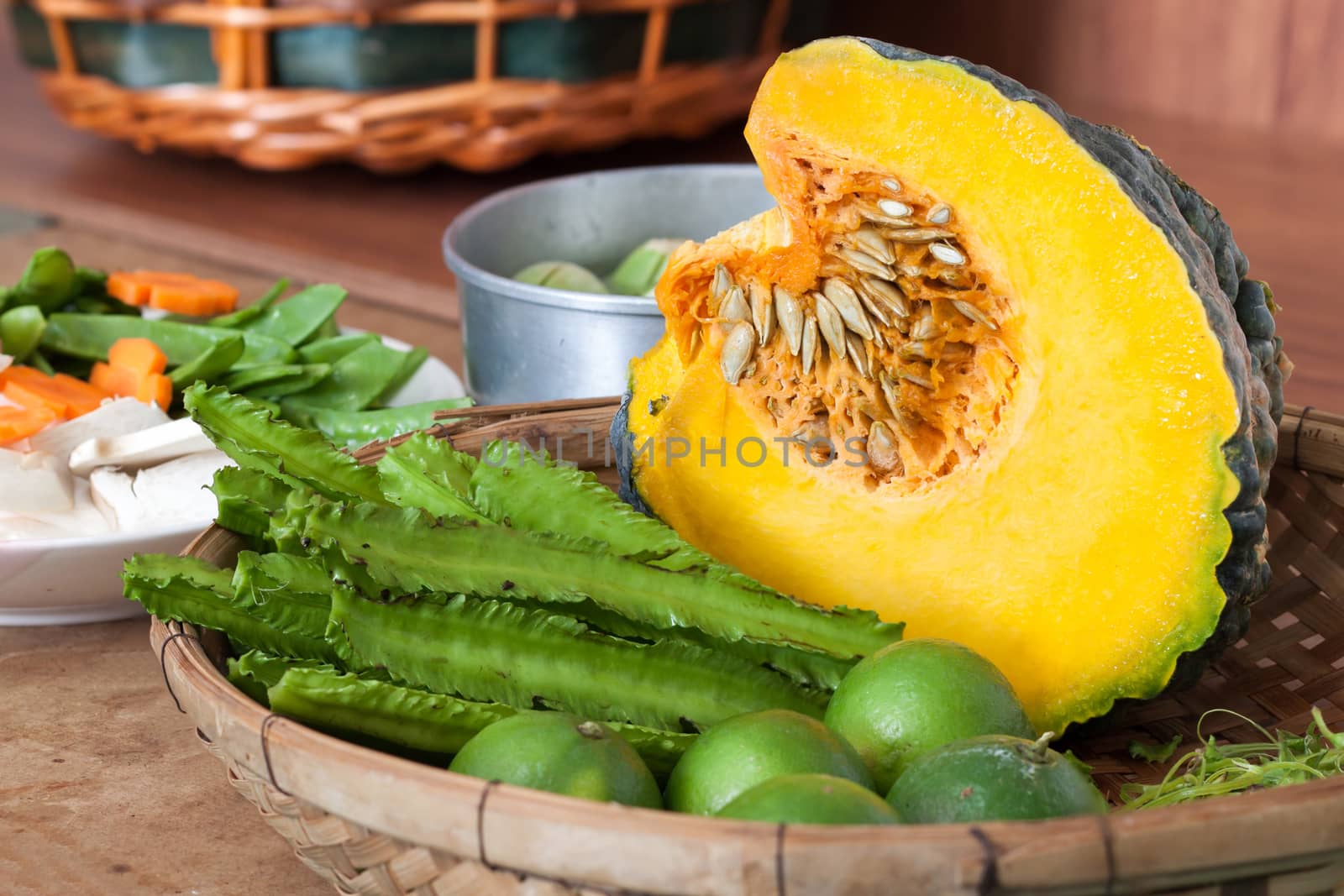 Princess bean (Psophocarpus tetragonolobus) and pumpkin and vegetable split In bamboo basket for cooking