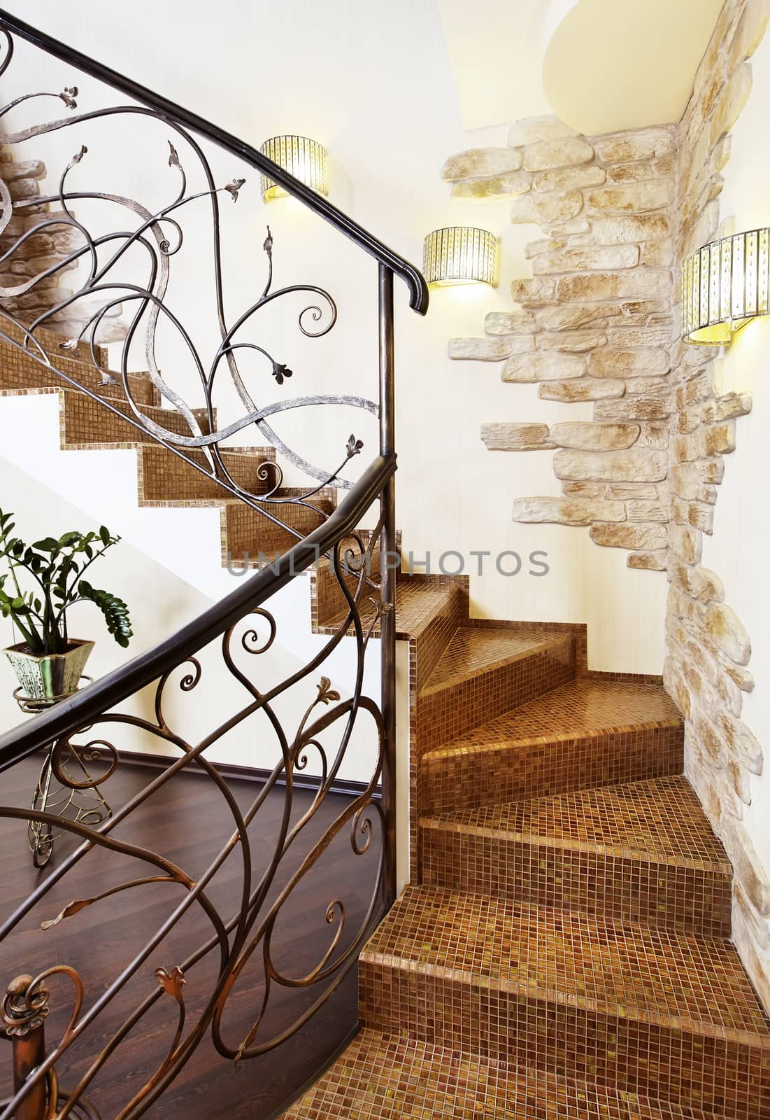 Classical mosaic stairs with ornamental handrail in hallway with stone decors