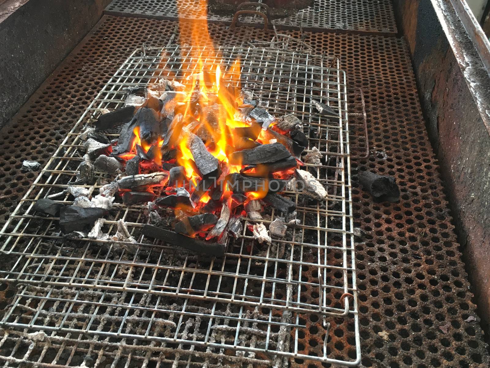 Background of empty hot Charcoal BBQ. Flaming Grill closeup  before cooking.