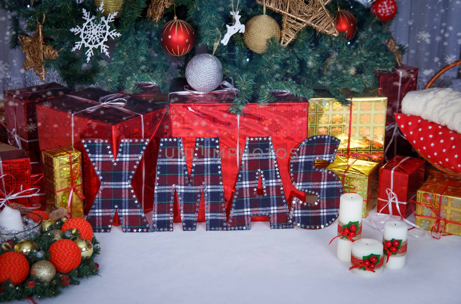 Handmade fabric letters XMAS under Christmas tree