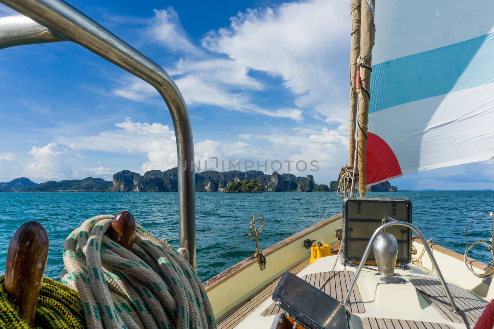 View of cliffs in thailand of the front of a sailing boat