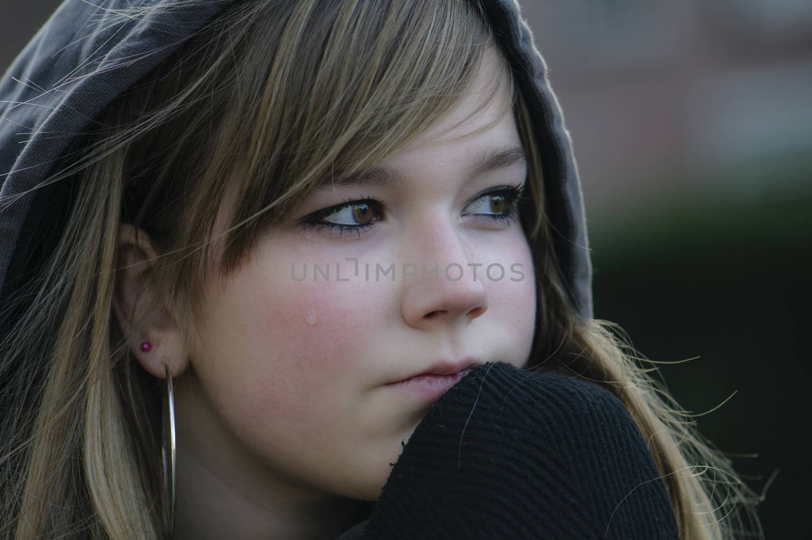 crying girl looks straight ahead and thinking