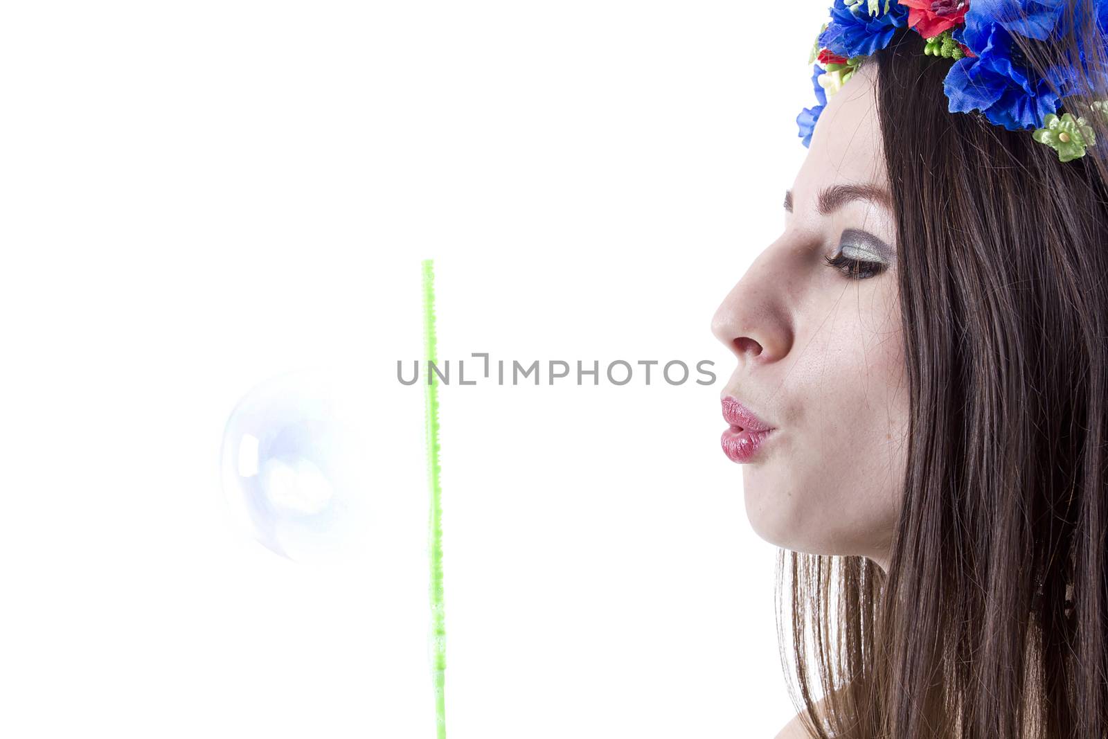 Studio portrait of a young beautiful woman with flower wreath on head.