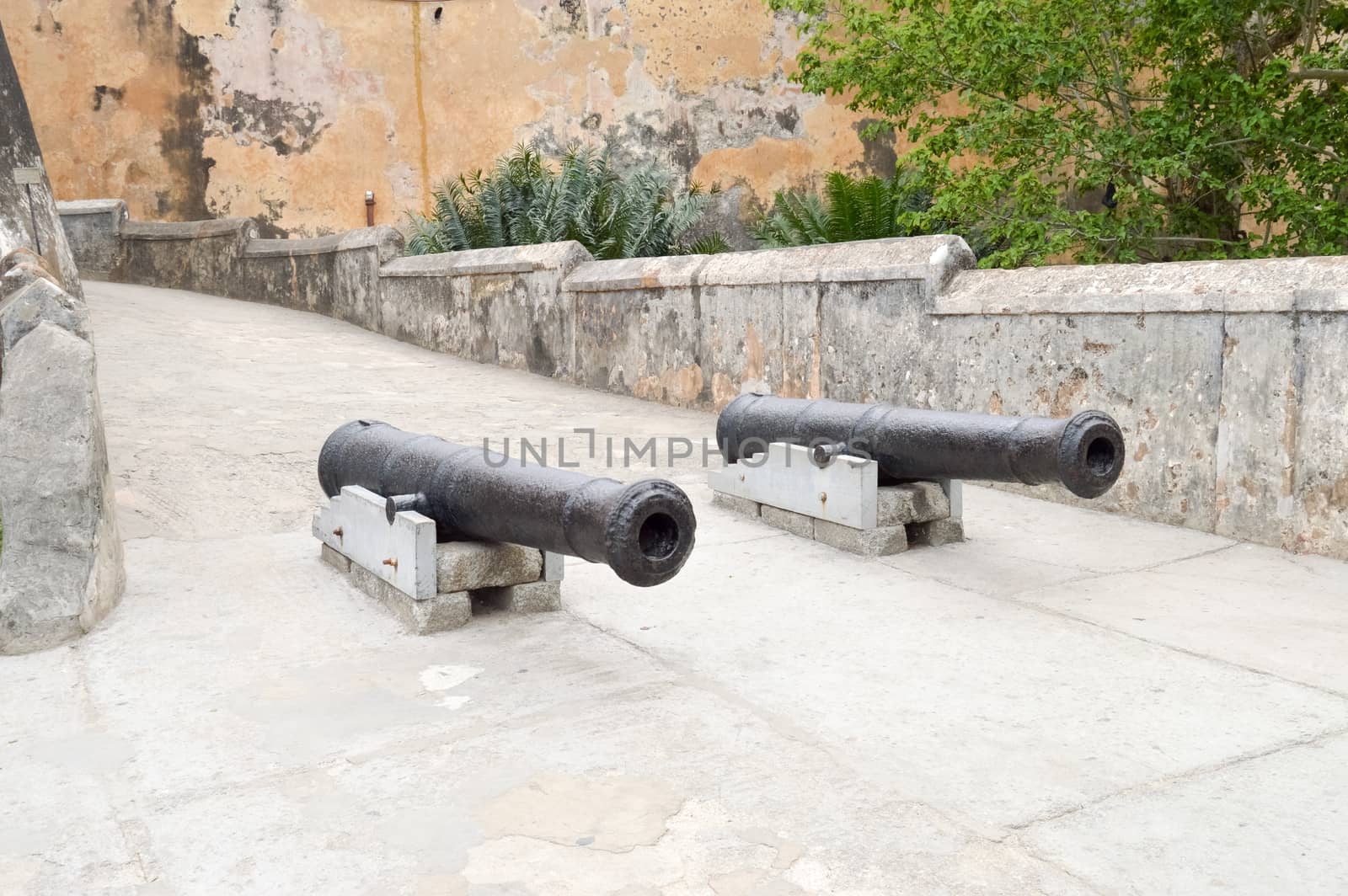 Old cast iron guns in front of the entrance to the Mombasa fortress in Kenya