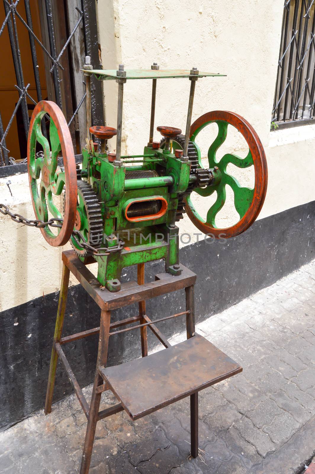 Old sugar cane press in a street  by Philou1000