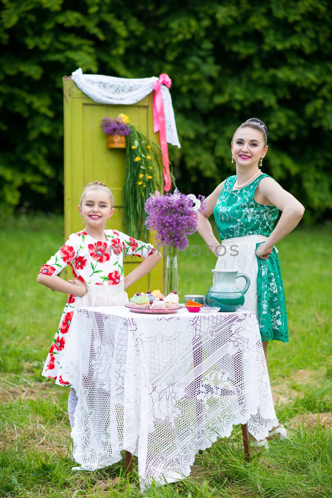 mother with daughter have a breakfast in the garden