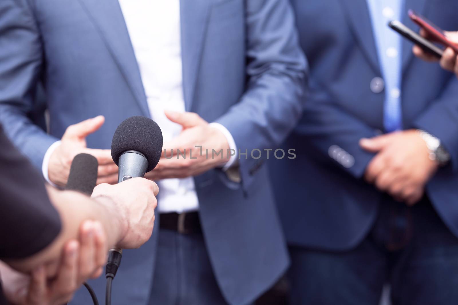 Reporters making interview with businessman, politician or spokesman. News conference.