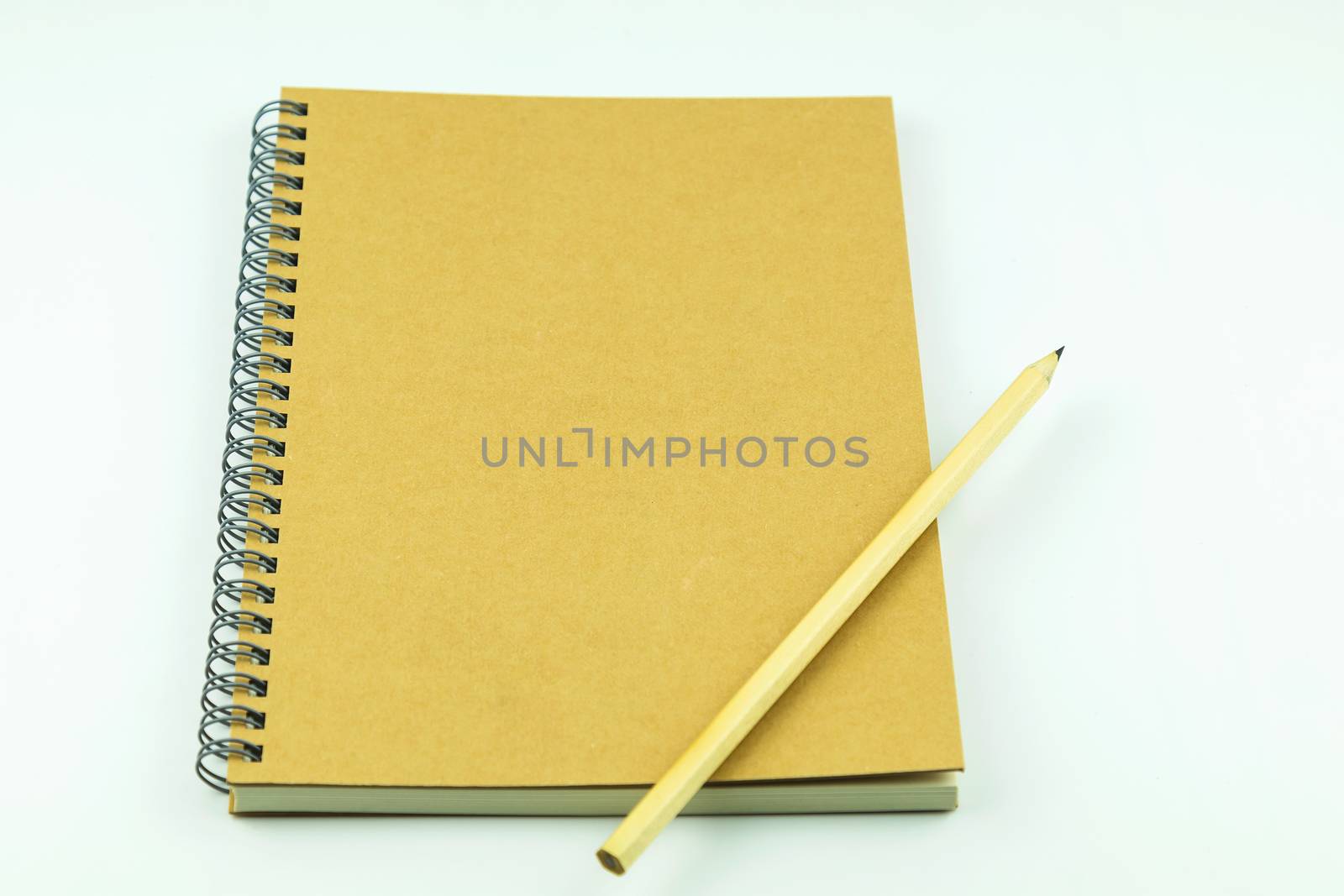 close notebook with pencil on white background