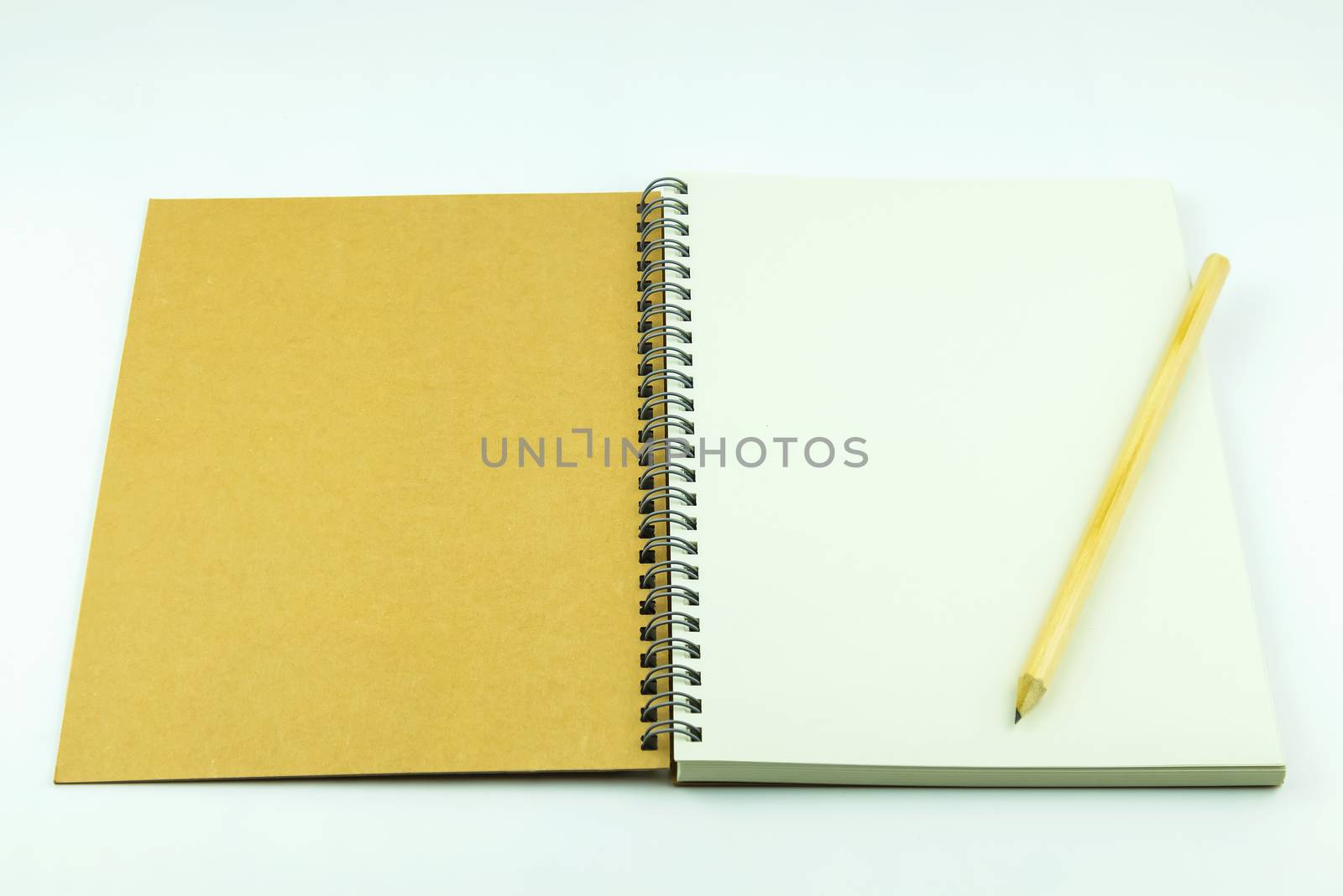 open notebook cover with pencil on white background