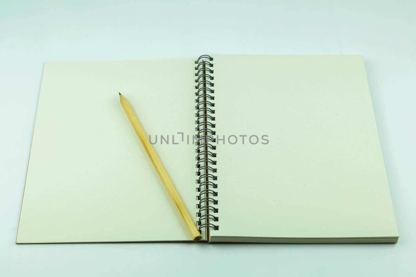 open notebook with pencil on white background