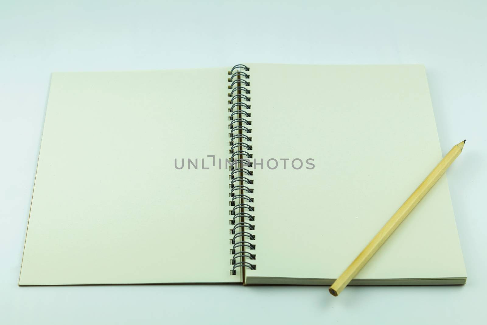 open notebook with pencil on white background