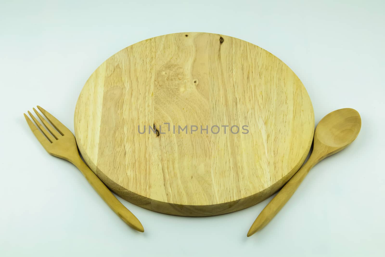 wood cutting board with spoon and fork on white background by luckyfim