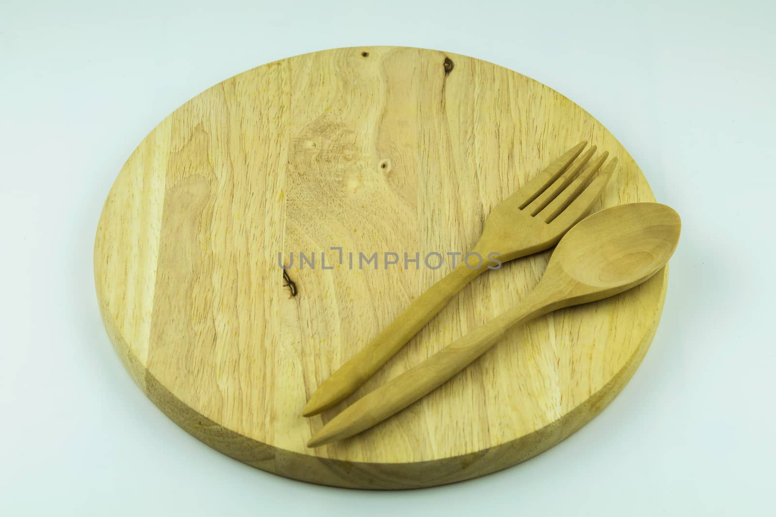 wood cutting board with spoon and fork on white background by luckyfim