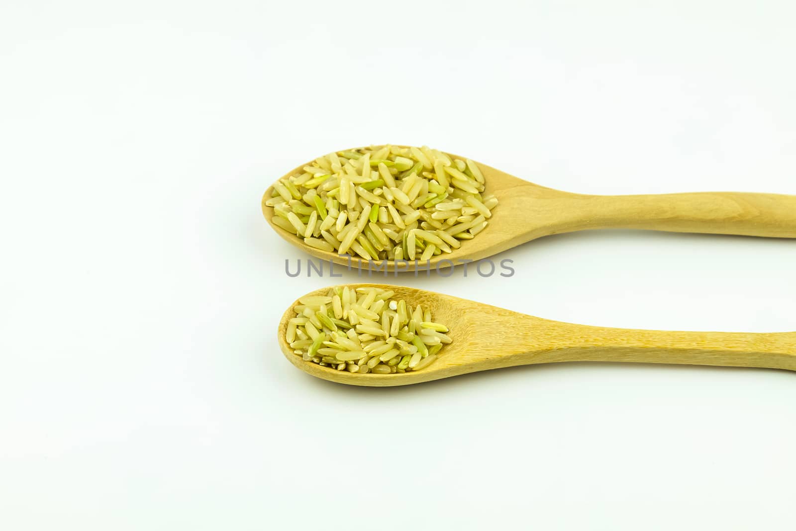 organic rice on wooden spoon with white background