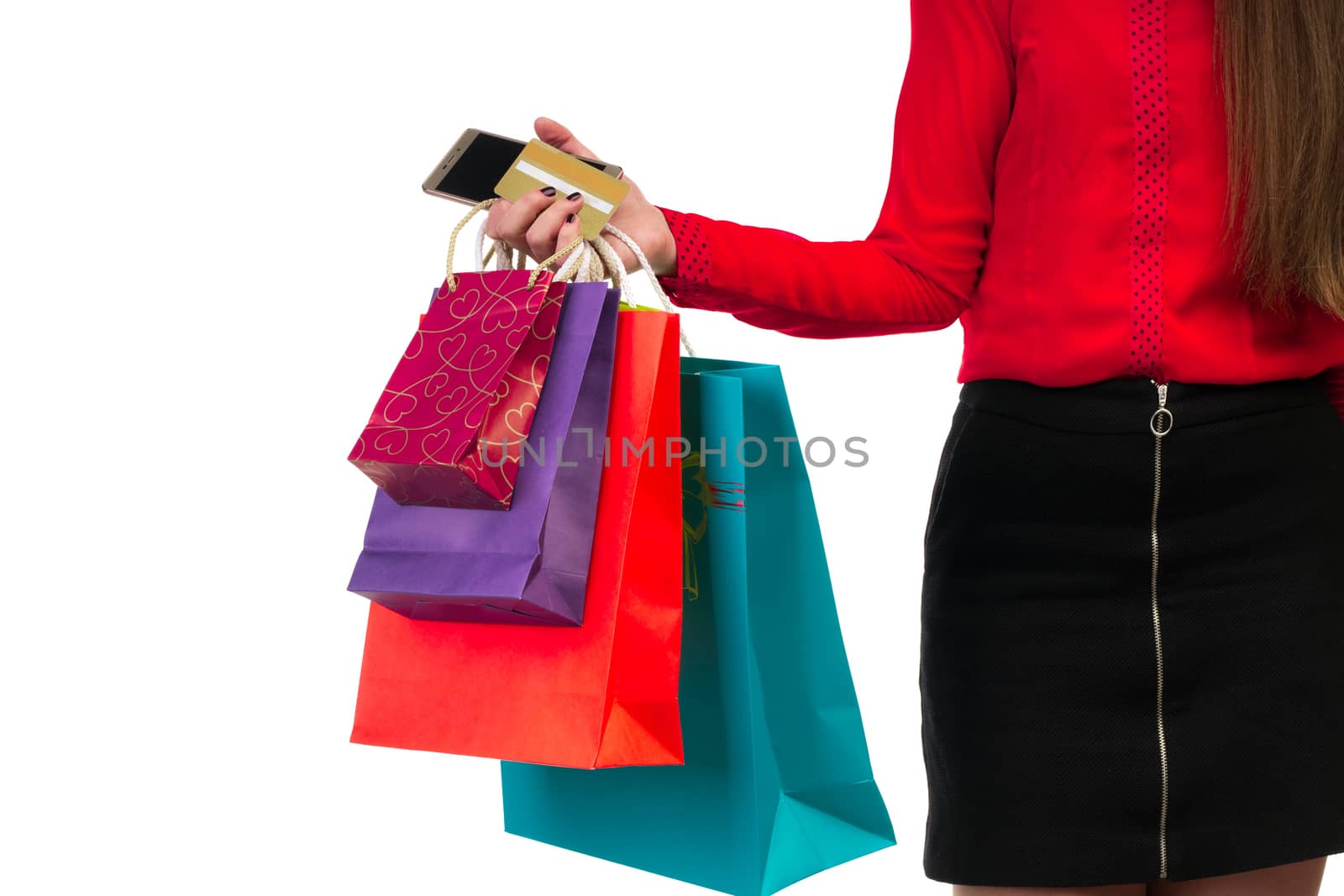 Woman holding colourful shopping paper bags, packages and banking credit card in her hand