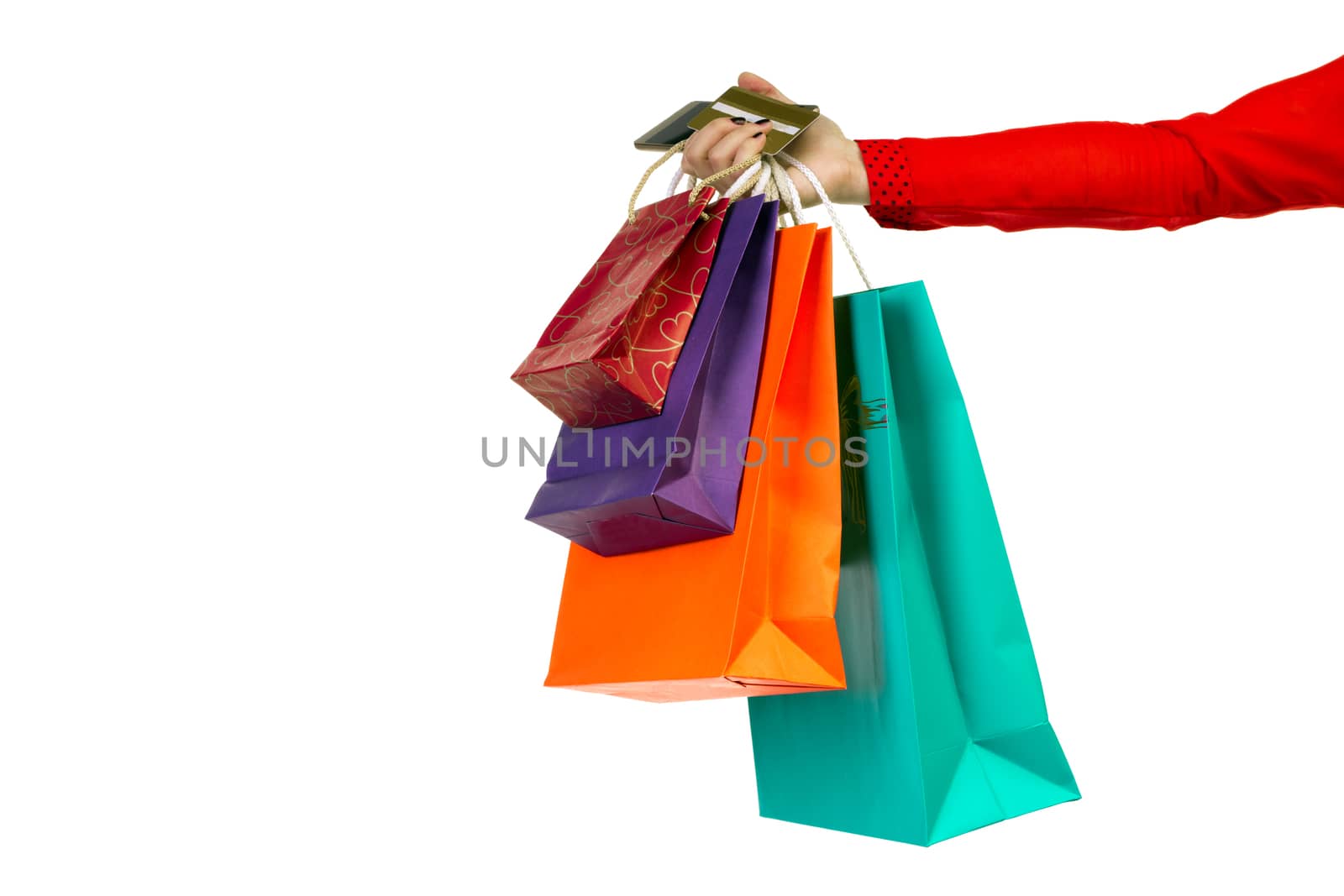 Woman holding colourful shopping paper bags, packages and banking credit card in her hand