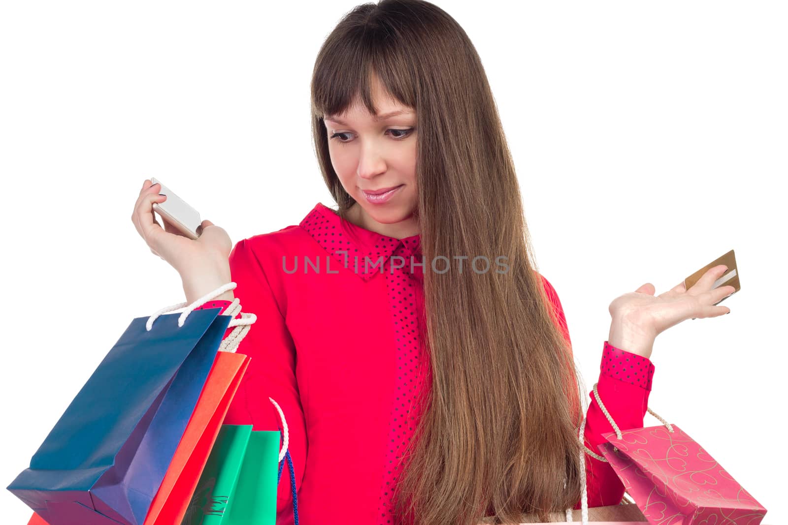 Young woman with banking credit card, colourful shopping paper bags and packages, smartphone