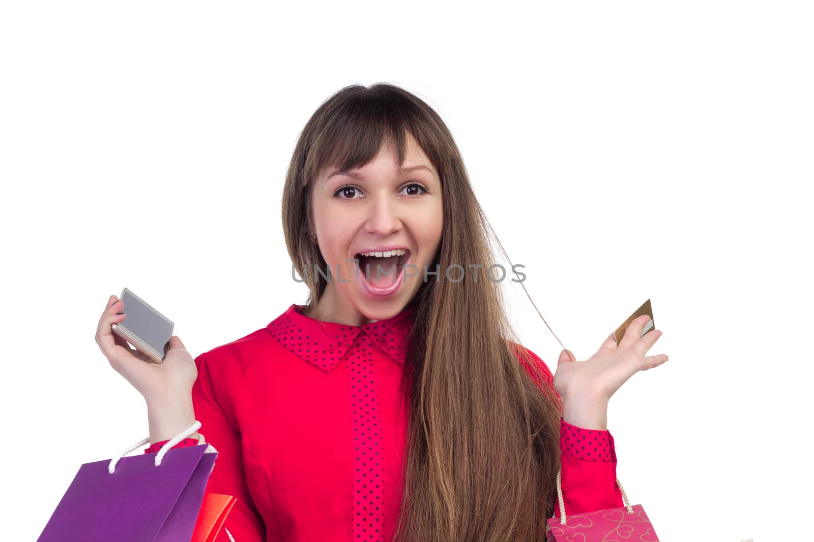 Young woman shopping with credit card holding colourful paper bags, packages and smartphone