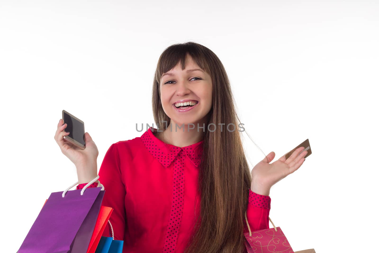 Young woman with banking credit card, colourful shopping paper bags and packages, smartphone