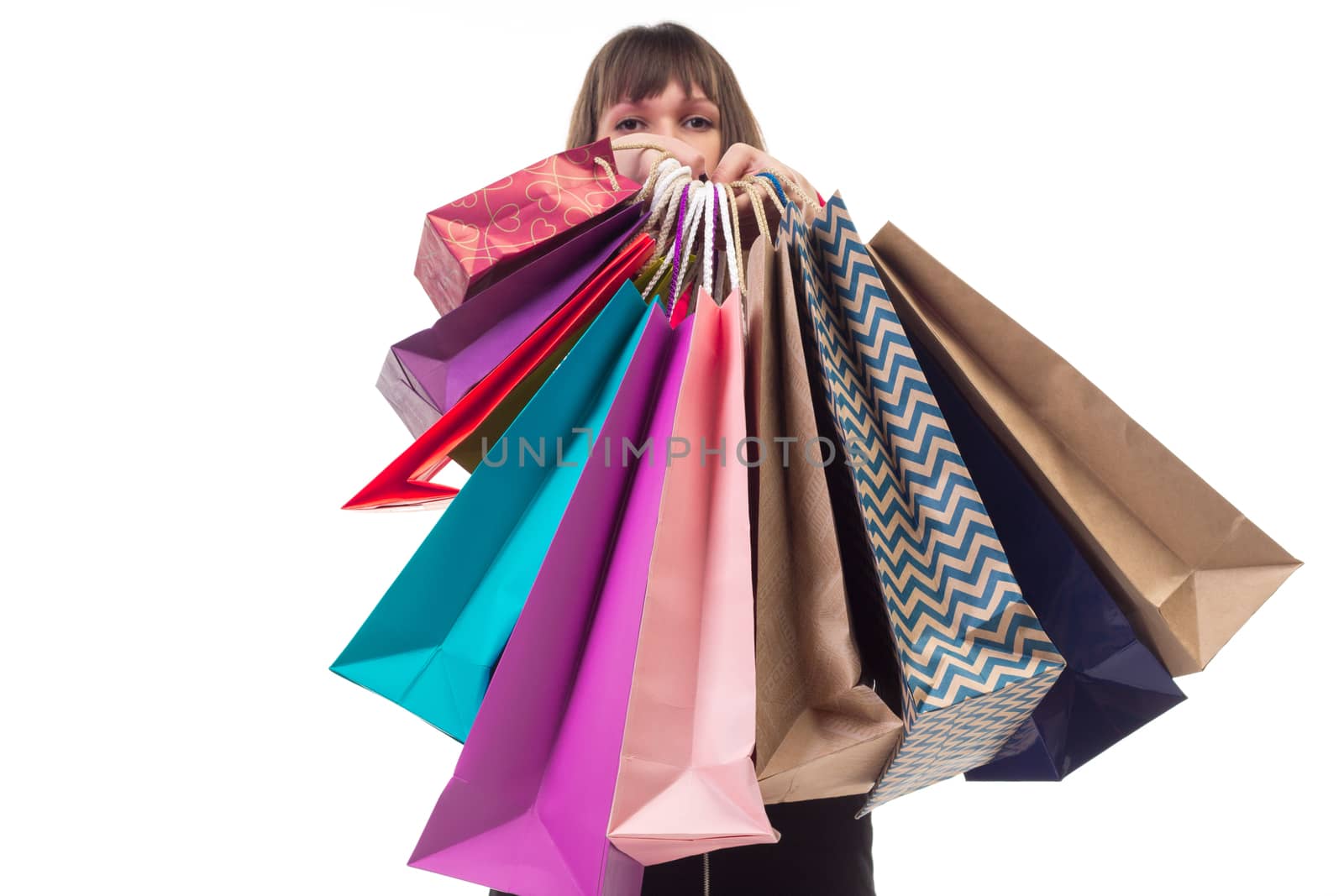 Close-up of shopping purchases, many colorful paper bags, packages in female hands
