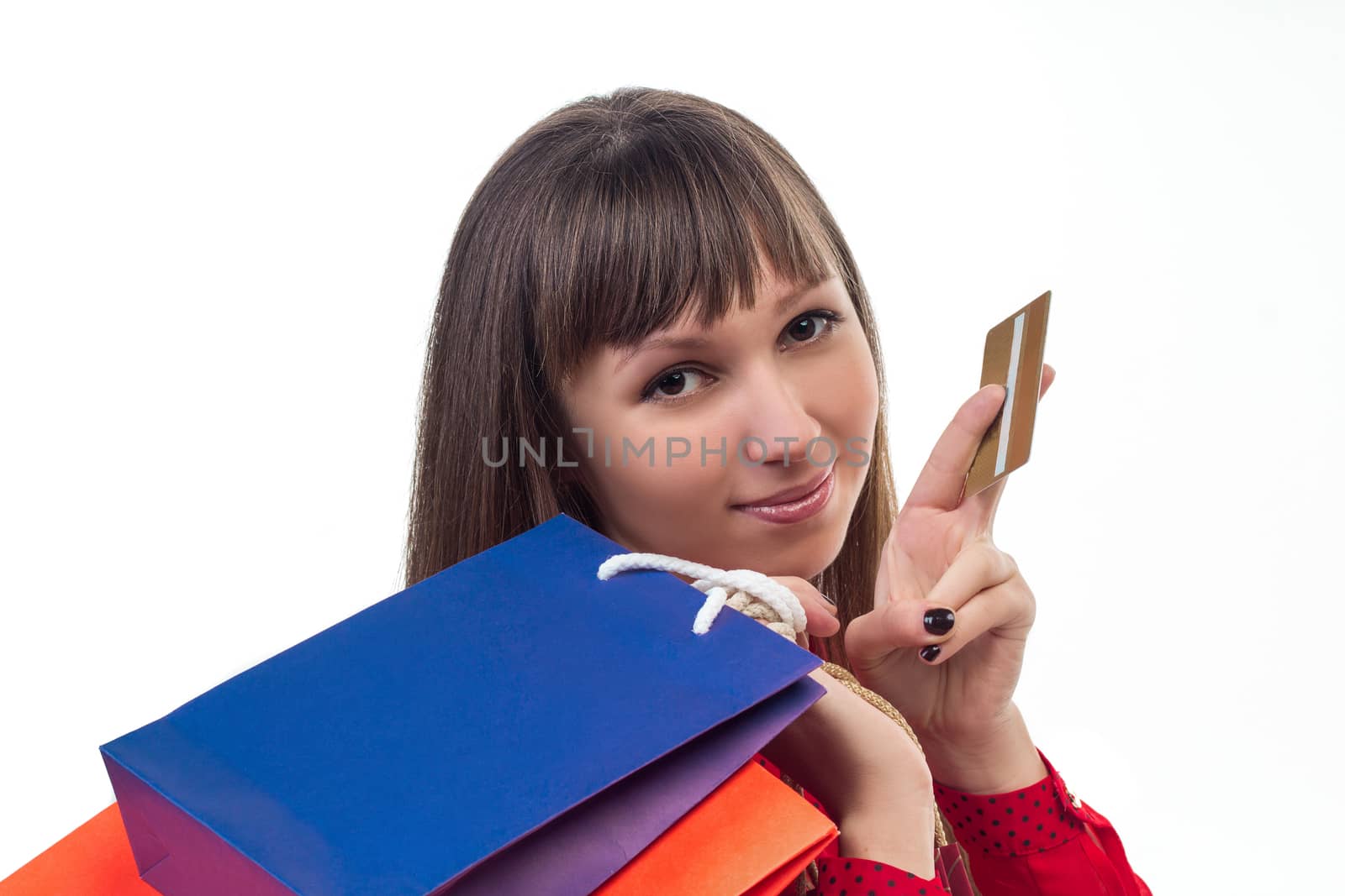 Young woman shopping with credit card holding colourful paper bags and packages