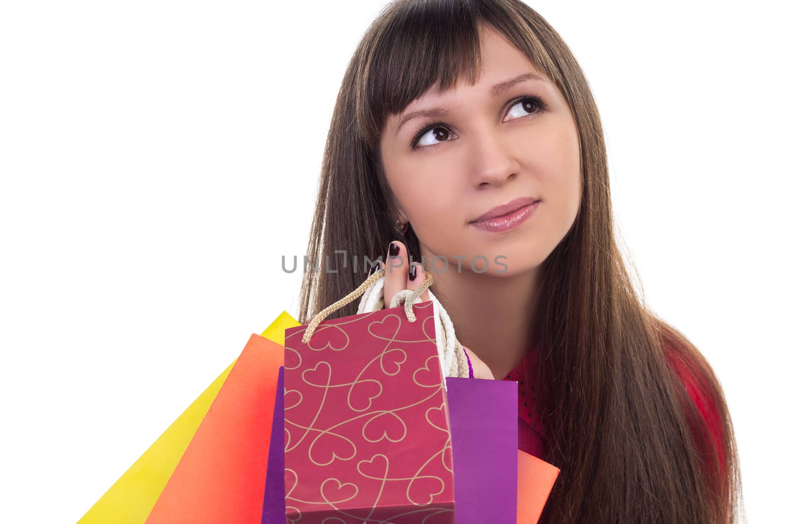 Close-up of smiling young woman face with colourful shopping paper bags