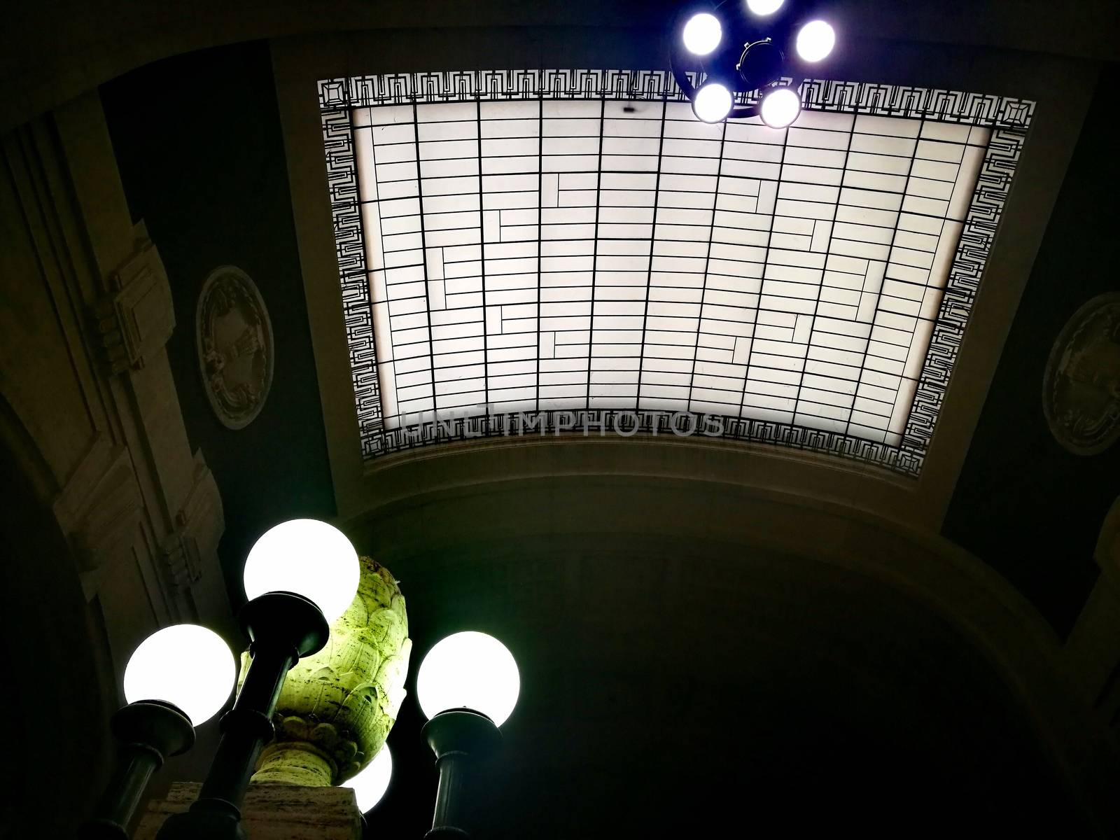 Architectural detail in Milan Central Station in Milan, Italy. Low angle view with dark shades and natural light from top.