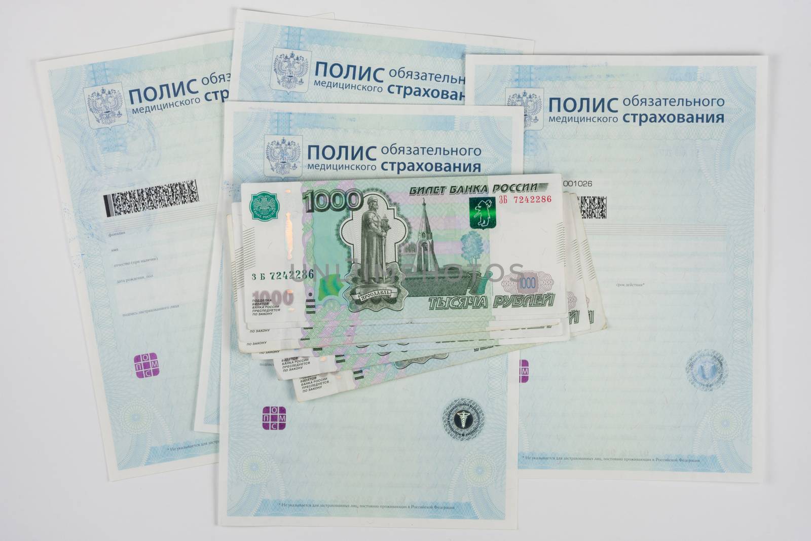 Russian money is on the policy of compulsory medical insurance, white background