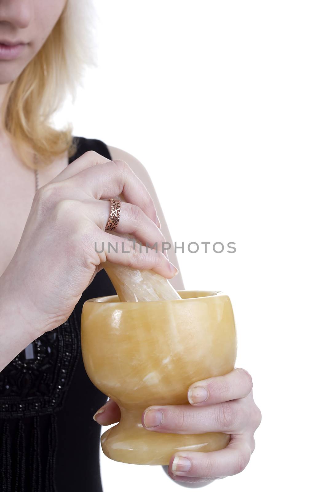 Mortar and pestle in the hands of women on a white background