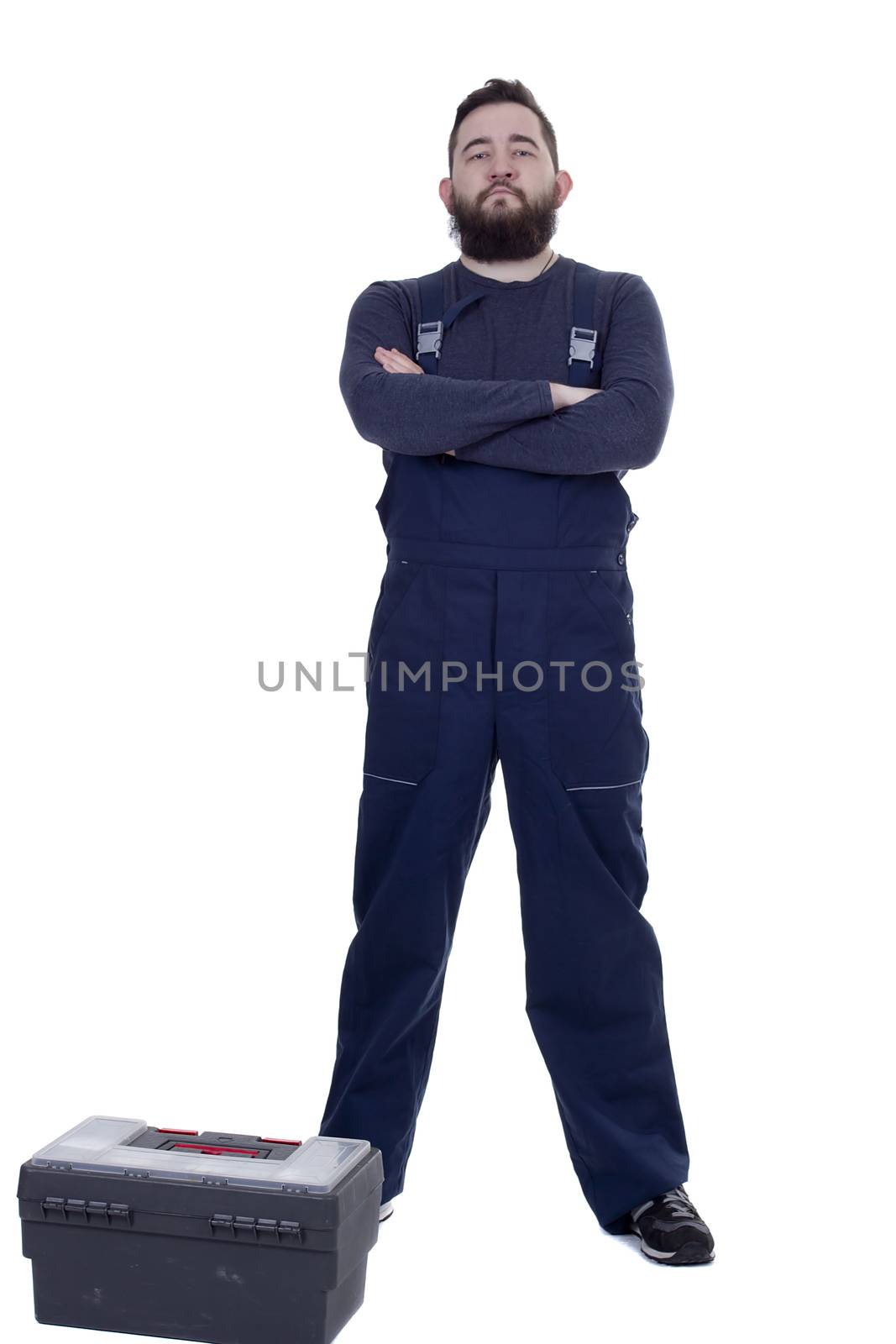 Bearded man mechanic with tool box on a white background